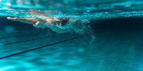 Male swimmer swimming underwater in a pool